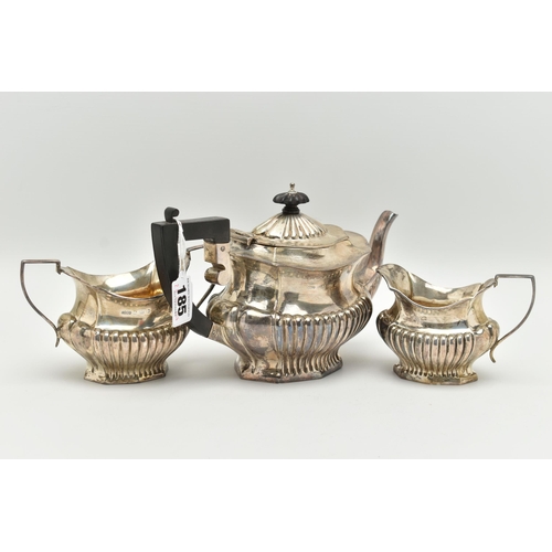 185 - AN EDWARD VII THREE PIECE SILVER TEA SET, comprising of a Queen Anne style tea pot, milk jug and sug... 