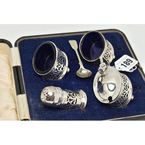 189 - A CASED GEORGE V SILVER FOUR PIECE CRUET SET WITH FOLIATE PIERCED DECORATION, comprising oval salts ... 