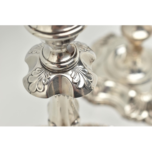 193 - A GEORGE V SILVER SET OF FOUR CANDLESTICKS  IN GEORGE II STYLE, with removable shaped square drip pa... 