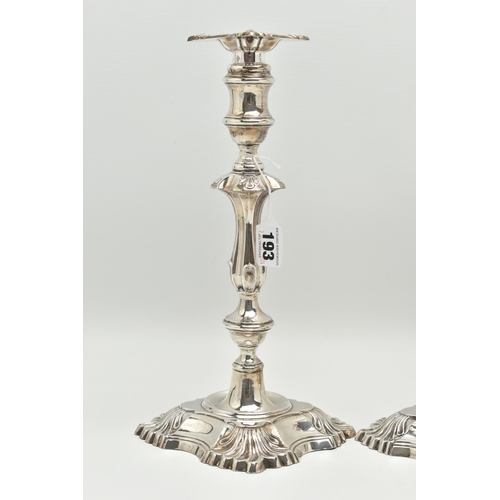 193 - A GEORGE V SILVER SET OF FOUR CANDLESTICKS  IN GEORGE II STYLE, with removable shaped square drip pa... 