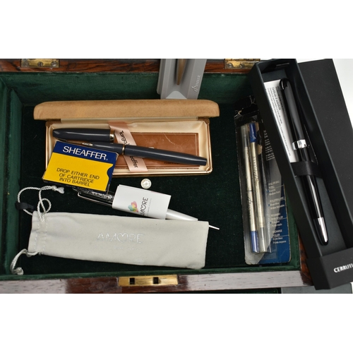 208 - A WOODEN BOX WITH ASSORTED PENS, a hinged wooden box encasing a selection of fountain pens, names to... 