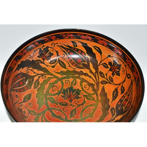 328 - A PILKINGTON'S BOWL, decorated with flowers and foliage on a mid-green exterior and a red/orange int... 