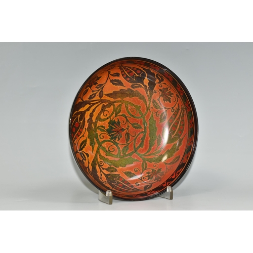 328 - A PILKINGTON'S BOWL, decorated with flowers and foliage on a mid-green exterior and a red/orange int... 