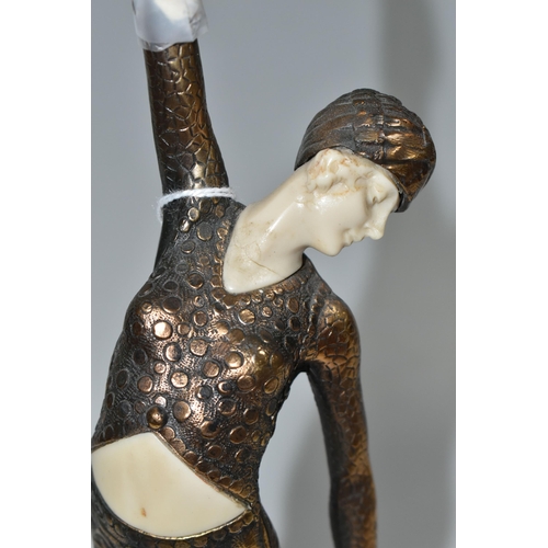 333 - AN ART DECO STYLE FIGURE, the female dancer surmounting a stepped geometric base, total height appro... 