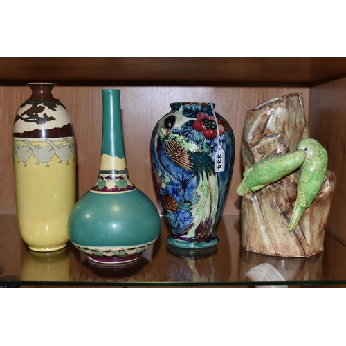 334 - A GROUP OF FOUR VASES, comprising a Thomas Forrester Trogon Ware vase tube lined with an exotic bird... 