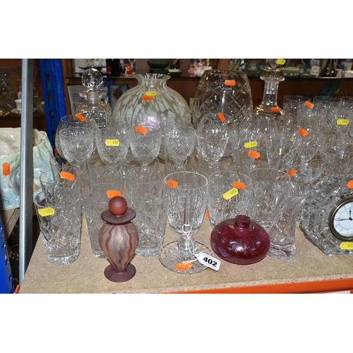 402 - A LARGE SELECTION OF GLASSWARE INCLUDING A WATERFORD CRYSTAL CLOCK, TOGETHER WITH A VARIETY OF THOMA... 