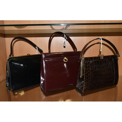 422 - THREE LADIES' VINTAGE HANDBAGS, comprising a brown French faux Croc bag, a claret patent leather col... 