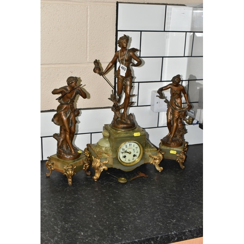 423 - A FRENCH CLOCK GARNITURE 'PAR FERRAND' in green onyx with spelter figures 'Chasse aux Papillons' wit... 