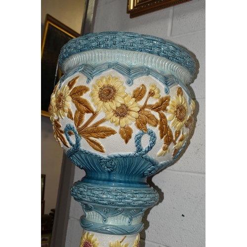 439 - A LARGE 19TH CENTURY BURMANTOFT FAIENCE JARDINIERE AND STAND, relief decorated panels of brown sunfl... 