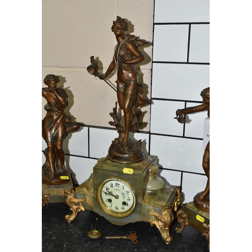 423 - A FRENCH CLOCK GARNITURE 'PAR FERRAND' in green onyx with spelter figures 'Chasse aux Papillons' wit... 