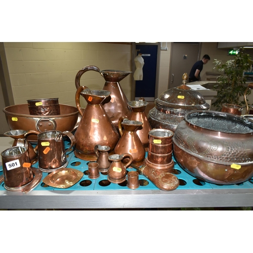 501 - A VARIETY OF COPPERWARE, comprising a selection of measuring vessels, tankards, an 'arts and crafts'... 