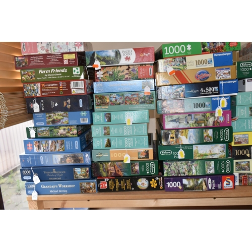 394 - A COLLECTION OF MODERN BOXED JIGSAWS, to include examples by Ravensburger, Jumbo (Wasgij), Gibsons, ... 