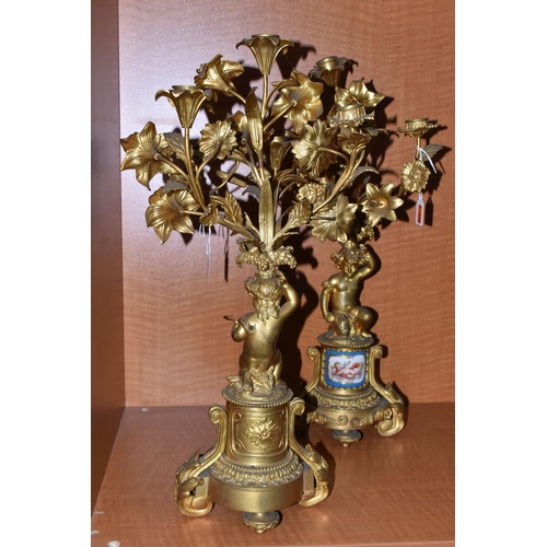 710 - A PAIR OF MID 19TH GILT METAL candelabra, the upper section of floral form fitted with candle holder... 