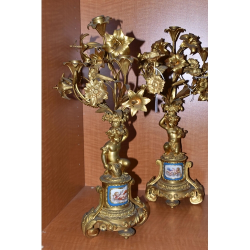 710 - A PAIR OF MID 19TH GILT METAL candelabra, the upper section of floral form fitted with candle holder... 