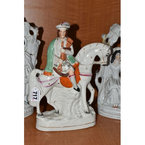 717 - THREE VICTORIAN STAFFORDSHIRE FIGURES, comprising two identical 'Fortune Teller' figure groups, heig... 