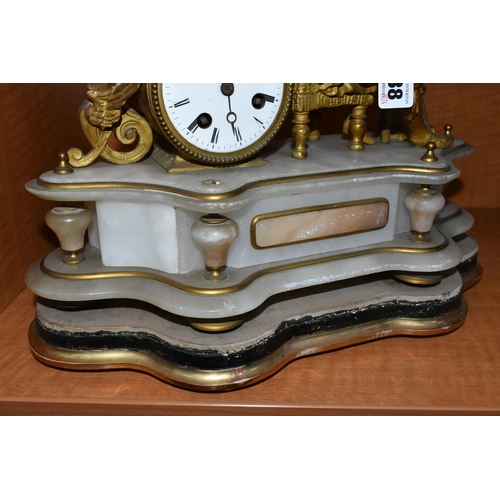 738 - A LATE 19TH CENTURY GILT METAL AND ALABASTER MANTEL CLOCK, modelled as an artist seated beside the d... 