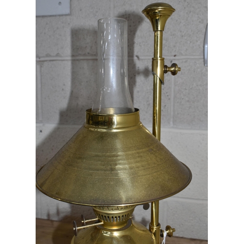 775 - A MODERN BRASS OIL LAMP OF EARLY 20TH CENTURY STYLE, bears Pullman emblem to the reservoir, on an ad... 