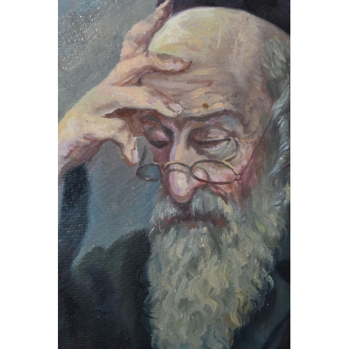 783 - A MID 20TH CENTURY PORTRAIT OF A RABBI, a seated Rabbi is reading from a book, his glasses are perch... 