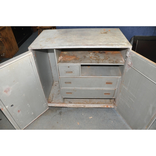 1086 - A VINTAGE STEEL WORKSHOP CABINET with two doors concealing three internal drawers and a hinged inner... 