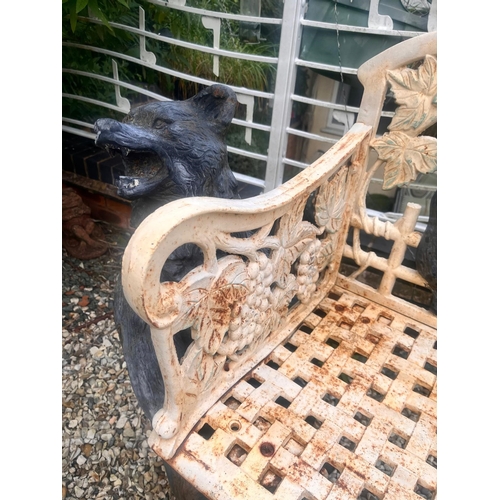 1001 - A CAST IRON BLACK FOREST STYLE GARDEN BENCH, the seat is supported by two angry black bears, the lat... 