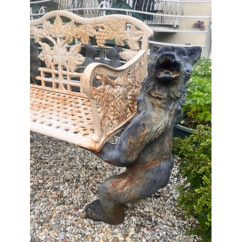 1001 - A CAST IRON BLACK FOREST STYLE GARDEN BENCH, the seat is supported by two angry black bears, the lat... 