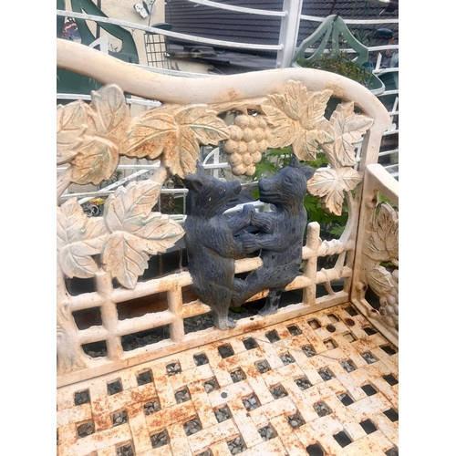 1001 - A CAST IRON BLACK FOREST STYLE GARDEN BENCH, the seat is supported by two angry black bears, the lat... 