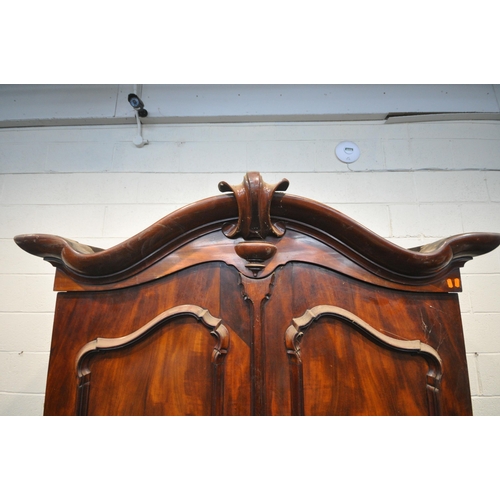 1277 - A VICTORIAN FLAME MAHOGANY LINEN PRESS, with an arched top, the full length double doors enclosing f... 