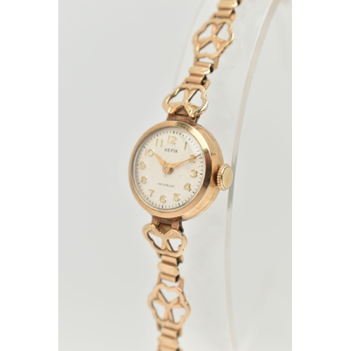 26 - A LADIES 9CT GOLD WRISTWATCH, manual wind, round silver dial signed 'Hefix', Arabic numerals, gold t... 