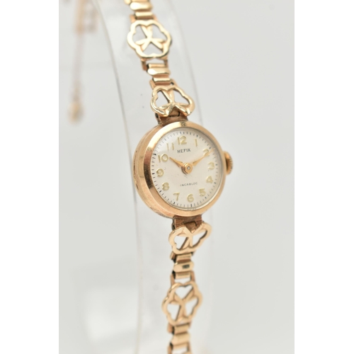 26 - A LADIES 9CT GOLD WRISTWATCH, manual wind, round silver dial signed 'Hefix', Arabic numerals, gold t... 