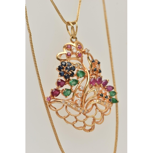 31 - A MIDDLE EASTERN GEM SET PENDANT, designed as an open work floral arrangement, set with rubies, sapp... 