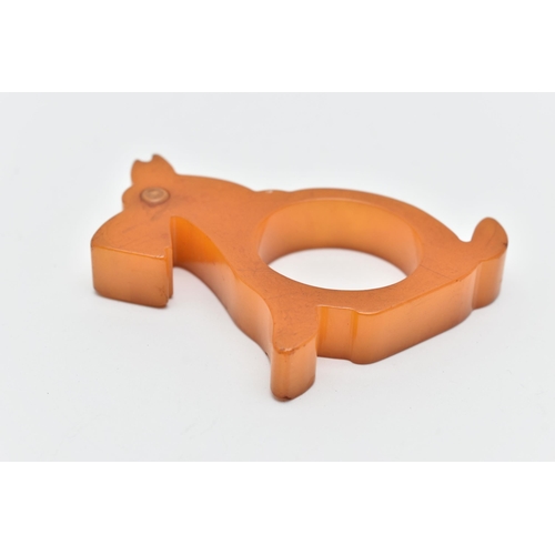 48 - A BAKELITE NAPKIN RING, designed as a butterscotch scotty dog, approximate height 73mm, approximate ... 