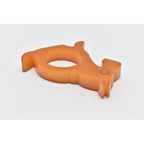 48 - A BAKELITE NAPKIN RING, designed as a butterscotch scotty dog, approximate height 73mm, approximate ... 