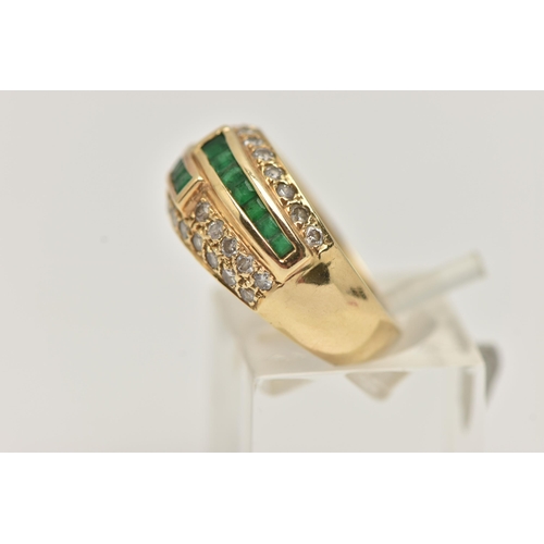 6 - A YELLOW METAL EMERALD AND DIAMOND RING, a domed ring, channel set with square cut emeralds and pave... 