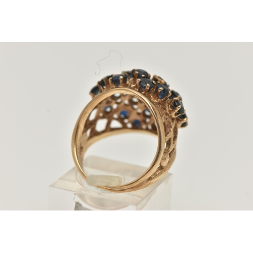 7 - A 9CT GOLD SAPPHIRE AND DIAMOND BOMBE RING, twenty circular cut sapphires and a single round brillia... 