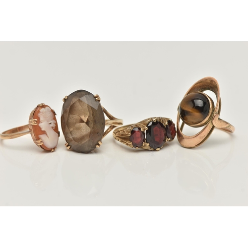 8 - FOUR GEM SET RINGS, to include a large oval cut smoky quartz, approximate length 22mm, prong set in ... 