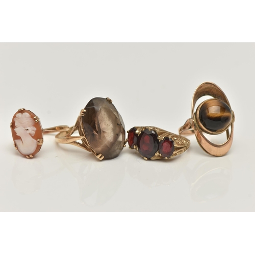 8 - FOUR GEM SET RINGS, to include a large oval cut smoky quartz, approximate length 22mm, prong set in ... 