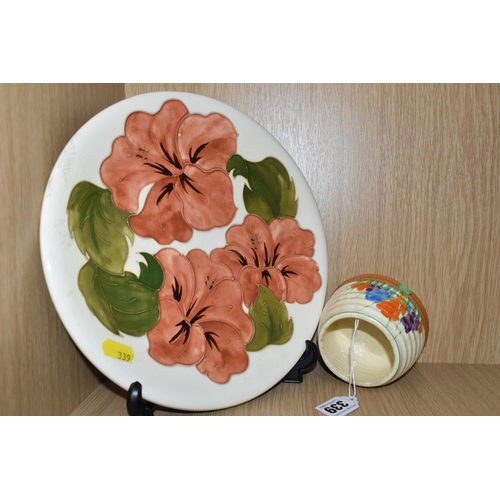 339 - A MOORCROFT POTTERY 'HIBISCUS' PATTERNED PLATE AND A CLARICE CLIFF SUGAR BOWL, comprising a coral an... 