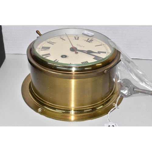 376 - A BRASS CASED SMITH ASTRAL BULKHEAD CLOCK, the cream dial with black Roman numerals, diameter includ... 