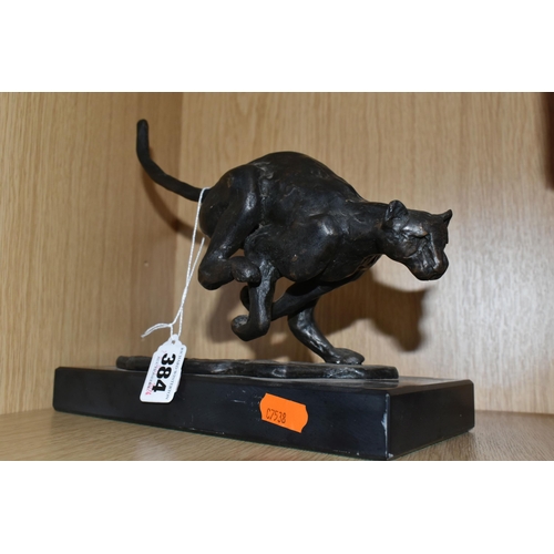 384 - A BRONZED RESIN FIGURE OF A RUNNING CHEETAH, supported by a black marble base, length 25cm x 11.5cm ... 