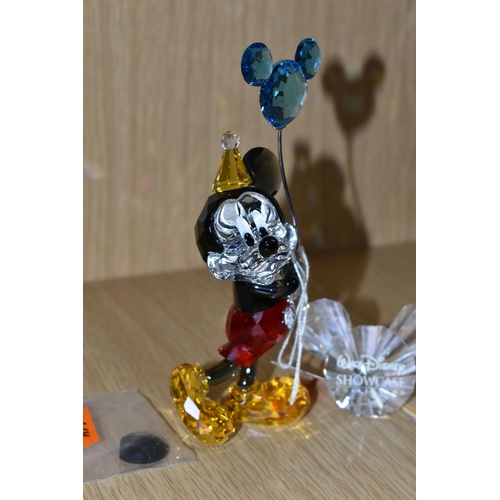 405 - A SWAROVSKI CRYSTAL 'MICKEY MOUSE - CELEBRATION' FIGURE, depicts Mickey in a party hat, holding a ba... 