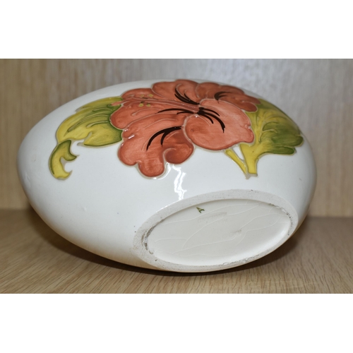 425 - A MOORCROFT POTTERY 'CORAL HIBISCUS' PATTERN BOWL, of oval form, tube lined with coral pink hibiscus... 