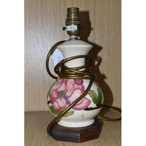 426 - A MOORCROFT POTTERY 'MAGNOLIA' PATTERN TABLE LAMP BASE, tube lined with pink magnolia flowers on a c... 