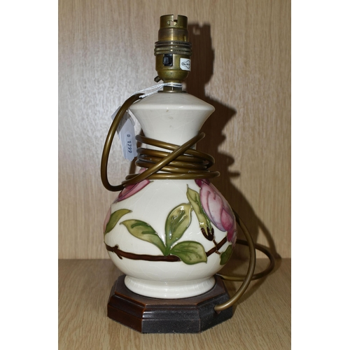 426 - A MOORCROFT POTTERY 'MAGNOLIA' PATTERN TABLE LAMP BASE, tube lined with pink magnolia flowers on a c... 