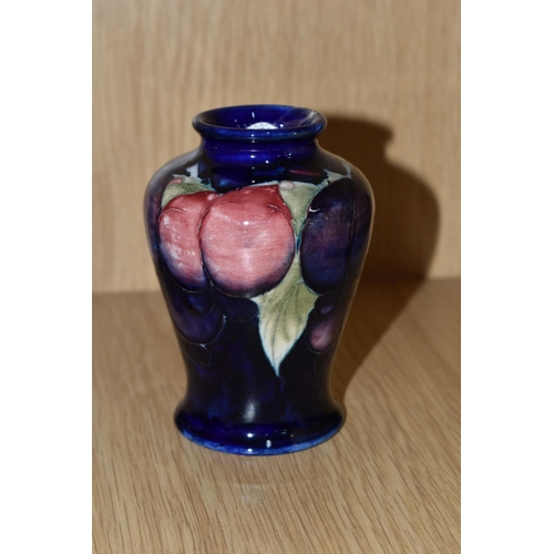 428 - A MOORCROFT POTTERY SMALL 'WISTERIA' PATTERN VASE, of baluster form, tube lined with red, purple and... 