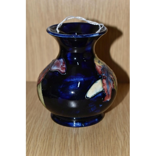 429 - A MOORCROFT POTTERY SMALL 'ORCHID' PATTERN VASE, of baluster form, tube lined with red, purple, blue... 