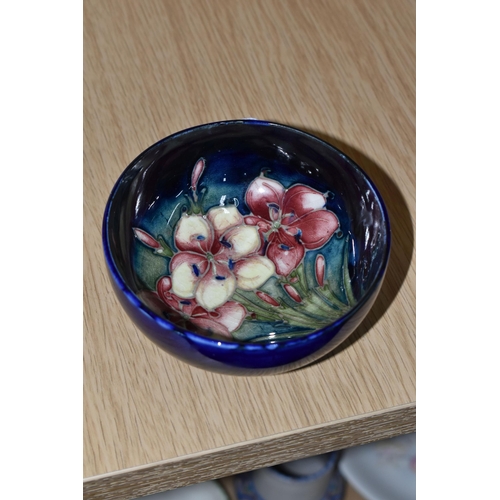 434 - A MOORCROFT POTTERY 'FREESIA' FOOTED BOWL, tube lined with pink and pale yellow Freesia on a dark bl... 