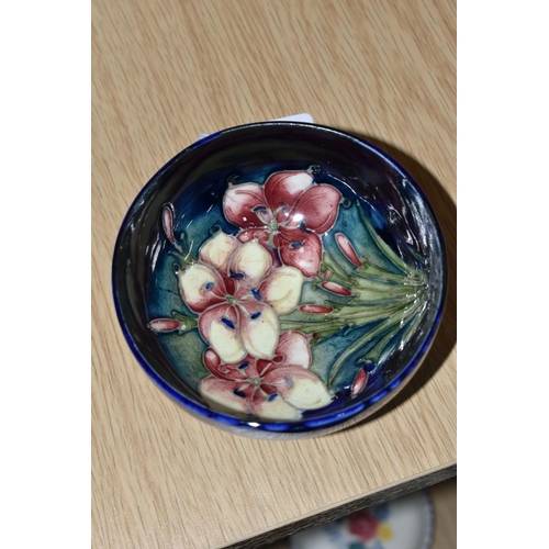 434 - A MOORCROFT POTTERY 'FREESIA' FOOTED BOWL, tube lined with pink and pale yellow Freesia on a dark bl... 