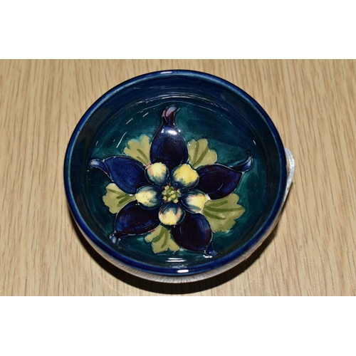 438 - A MOORCROFT POTTERY 'COLUMBINE' SMALL FOOTED BOWL, tube lined with a yellow and purple columbine on ... 