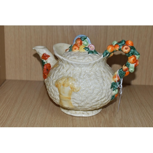 475 - A CLARICE CLIFF 'CELTIC HARVEST' TEAPOT, moulded and painted with fruits and wheatsheaves on a textu... 