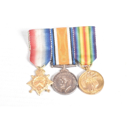 358 - A 1914 WWI STAR WITH BAR AND ROSETTE, a miniature WWI trio of medals, ribbon bar with rosette, the s... 